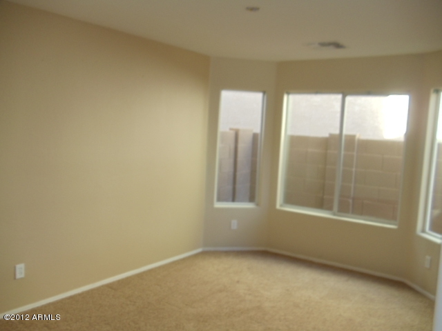 9204 West Payson Road Tolleson, AZ 85353 - Photo 3 of 17 a view of an empty room with a window
