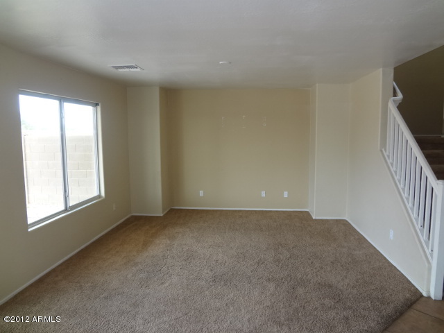 9204 West Payson Road Tolleson, AZ 85353 - Photo 4 of 17 a view of an empty room with a window