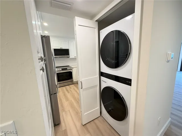 a view of a hallway with washer and dryer