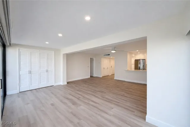 a view of empty room with wooden floor