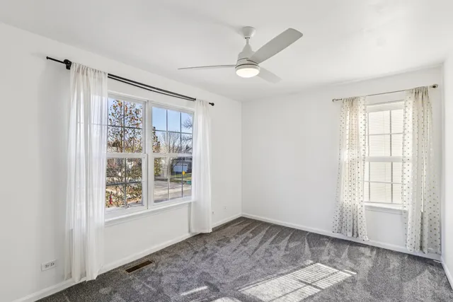 an empty room with a ceiling fan