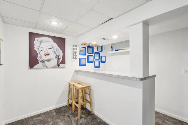 a room with pool table and wall paintings