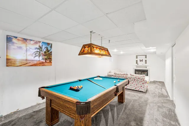a room with furniture and pool table