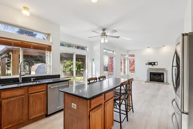 a kitchen with granite countertop a sink appliances and cabinets