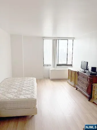 a bedroom with a bed and a window with kitchen view