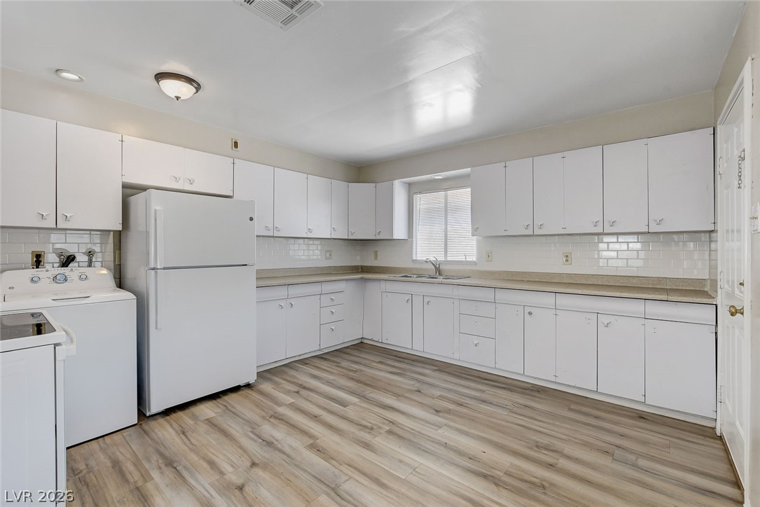 214 West Victory Road Henderson, NV 89015 - Photo 5 of 33 A well-equipped kitchen offering ample storage and an open layout for ease and functionality.