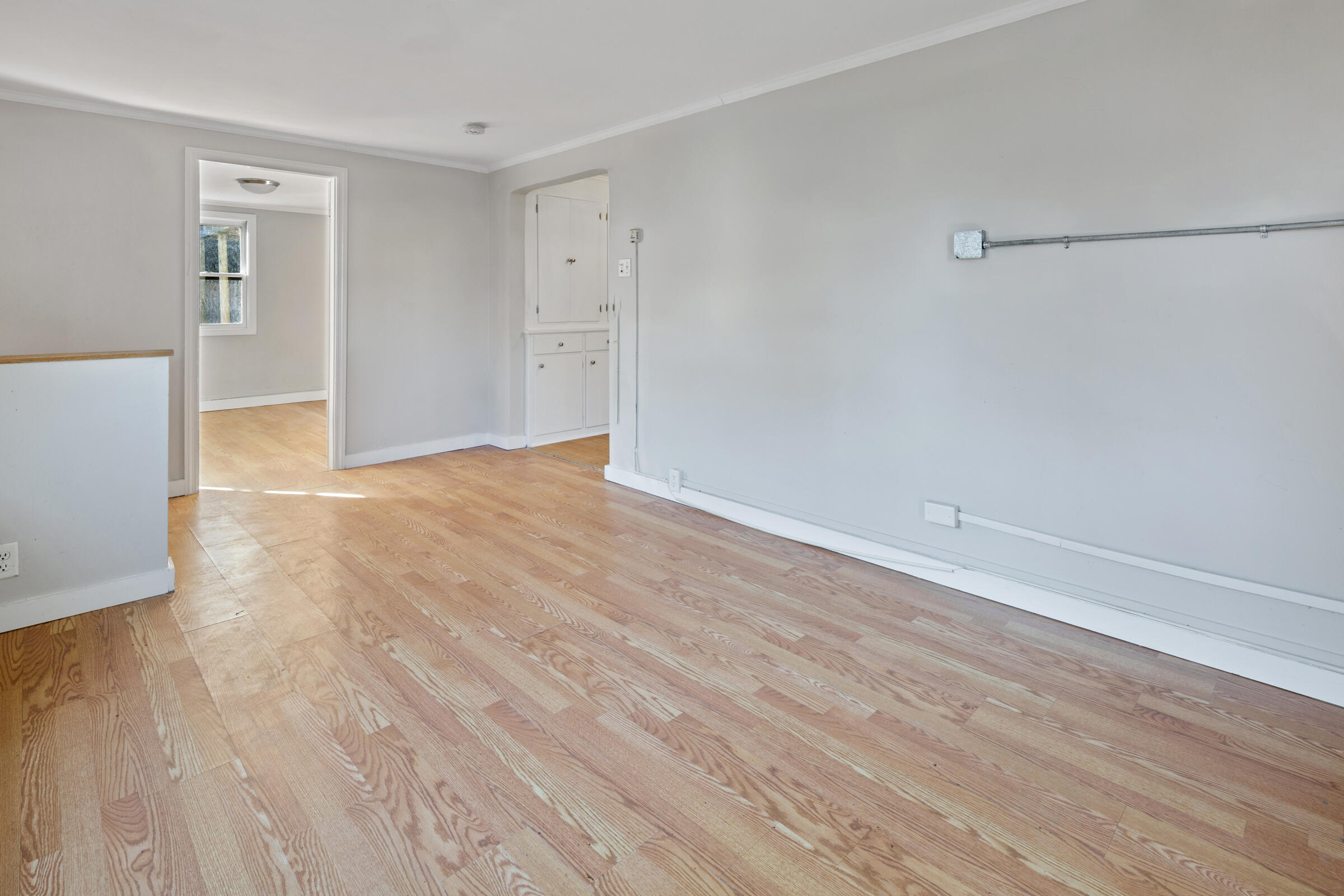 15 Bee Lane Centerville, MA 02632 - Photo 4 of 11 a view of an empty room with wooden floor and a window