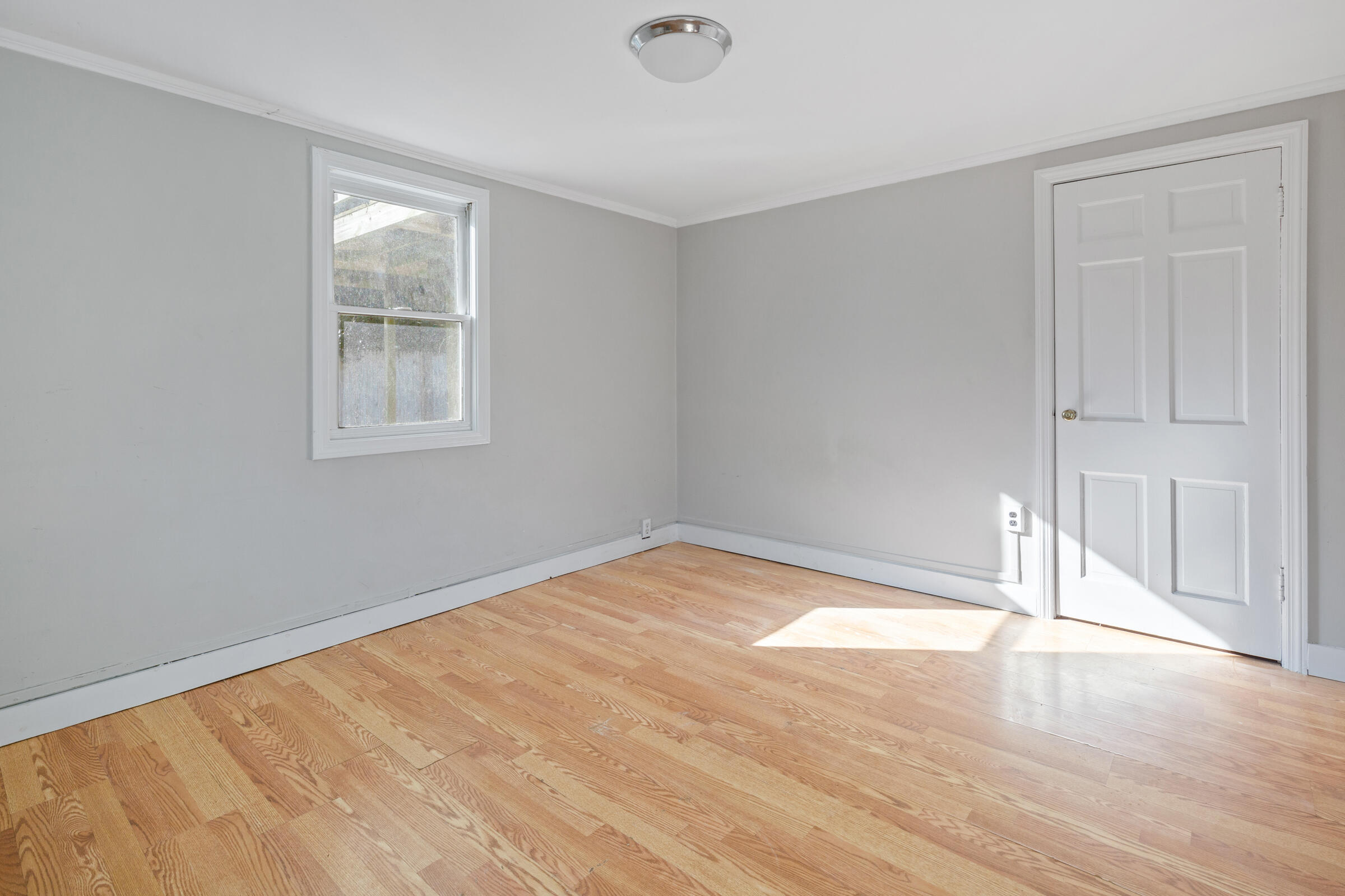15 Bee Lane Centerville, MA 02632 - Photo 6 of 11 an empty room with wooden floor and windows
