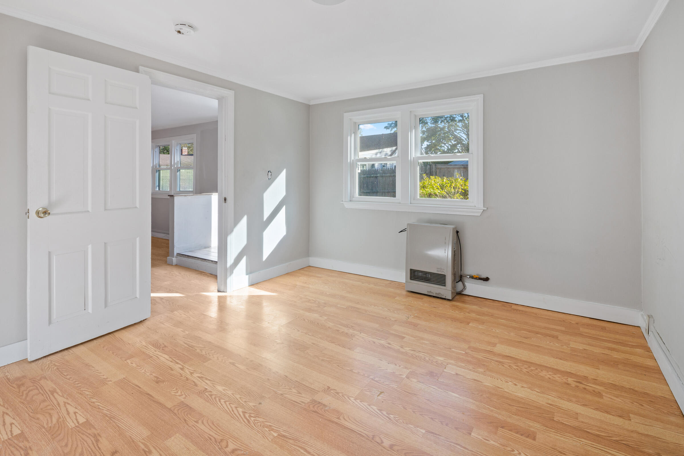 15 Bee Lane Centerville, MA 02632 - Photo 7 of 11 a view of an empty room with window and wooden floor
