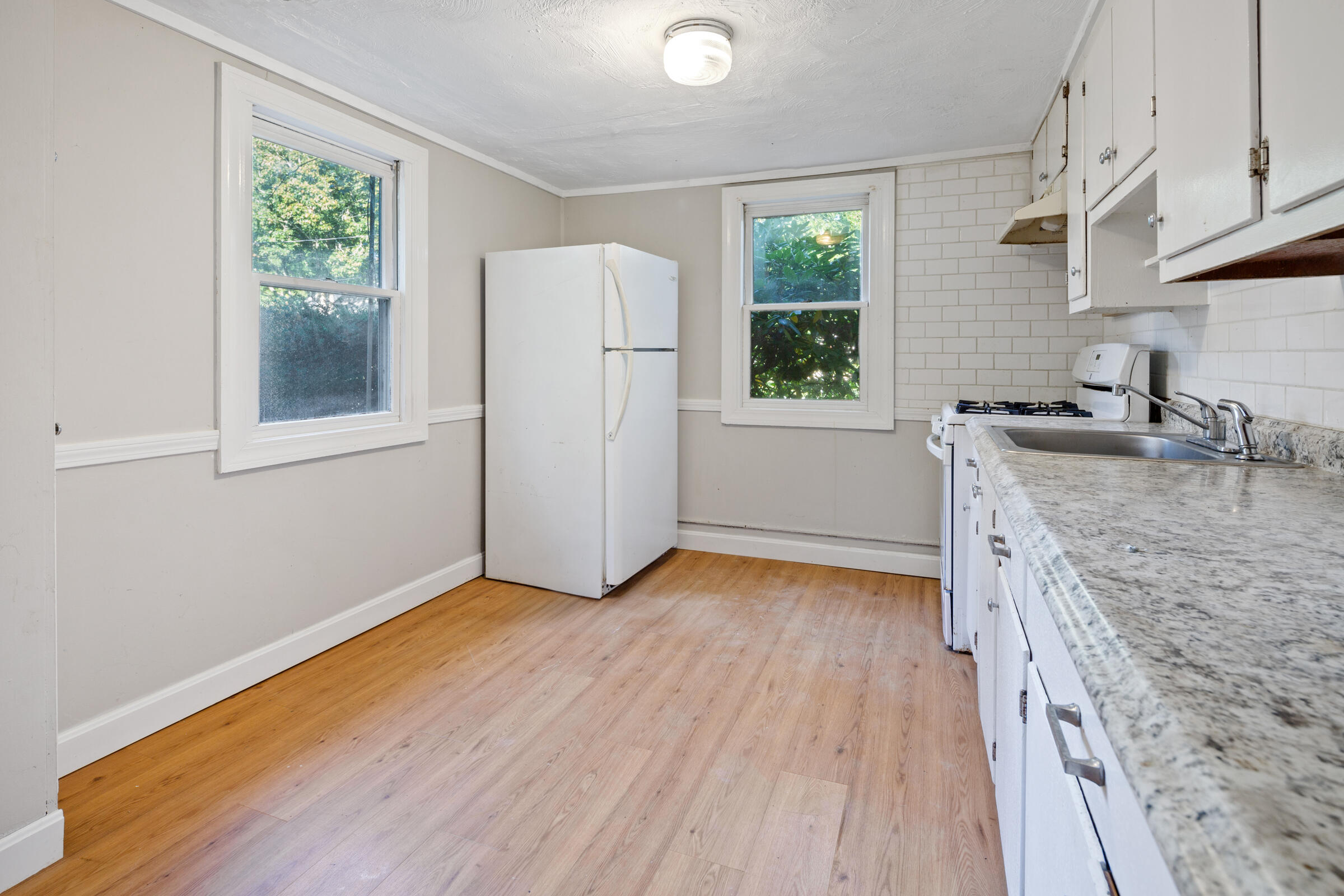 15 Bee Lane Centerville, MA 02632 - Photo 9 of 11 an empty room with wooden floor and a window