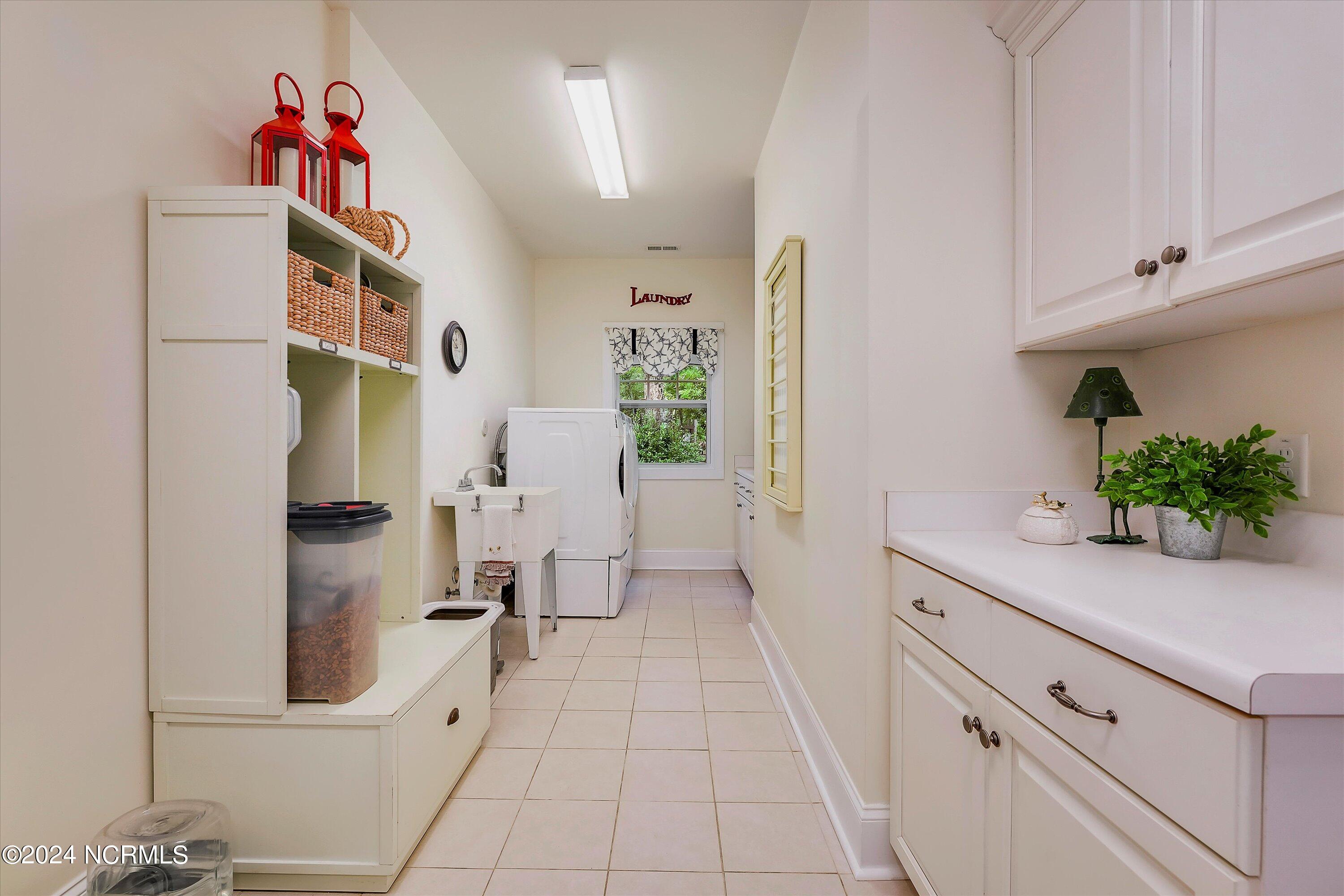 3849 Hallmark Road Northeast Leland, NC 28451 - Photo 13 of 37 Convenient laundry room, space for folding, hanging, and storage.