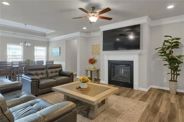 a living room with furniture a flat screen tv and a fireplace