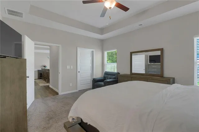 a bedroom with a large bed and a chandelier