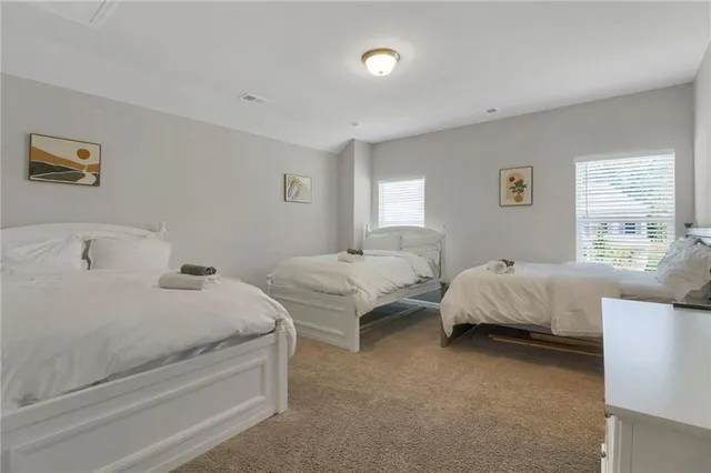 a bedroom with two beds and a window