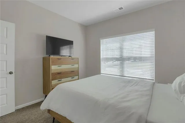 a bedroom with a bed and a television