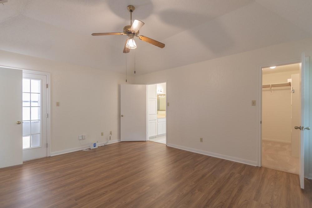 2411 Raintree Path Round Rock, TX 78664 - Photo 12 of 28 an empty room with wooden floor fan and window