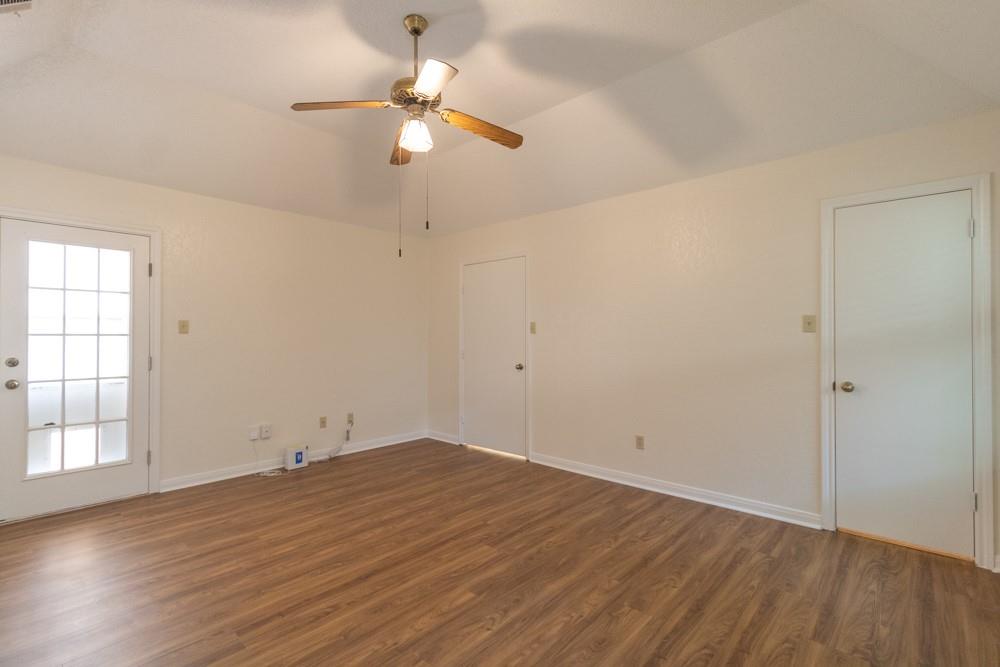 2411 Raintree Path Round Rock, TX 78664 - Photo 13 of 28 an empty room with wooden floor fan and windows