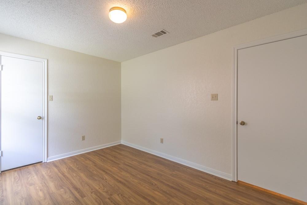 2411 Raintree Path Round Rock, TX 78664 - Photo 19 of 28 a view of an empty room with wooden floor and a window