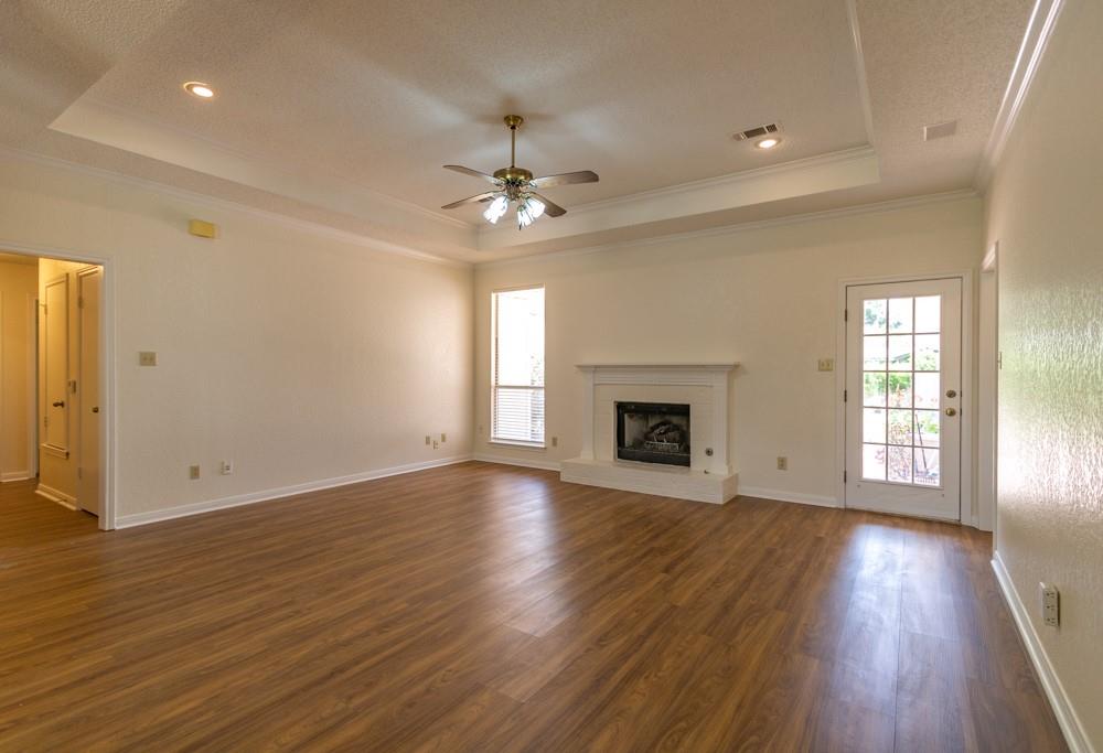 2411 Raintree Path Round Rock, TX 78664 - Photo 2 of 28 an empty room with wooden floor fireplace and windows