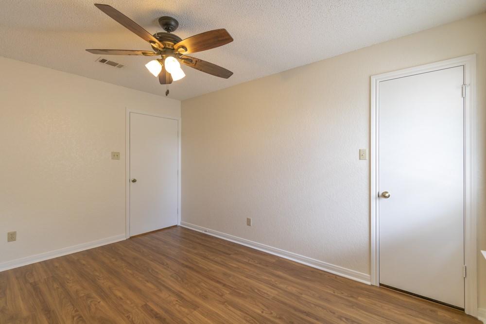 2411 Raintree Path Round Rock, TX 78664 - Photo 21 of 28 an empty room with wooden floor and fan