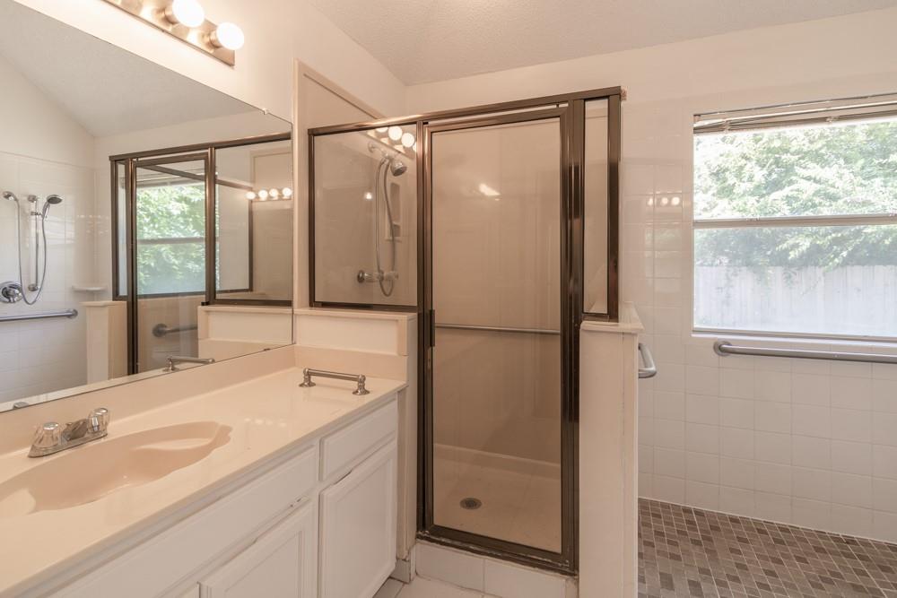2411 Raintree Path Round Rock, TX 78664 - Photo 4 of 28 a bathroom with a shower sink and mirror