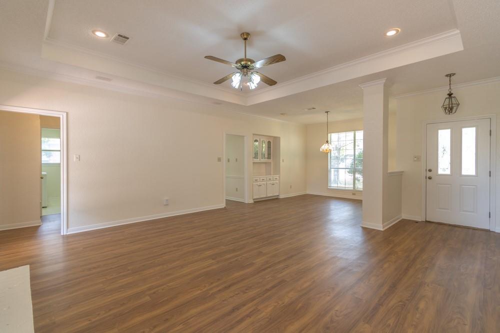 2411 Raintree Path Round Rock, TX 78664 - Photo 7 of 28 a view of an empty room with window and wooden floor
