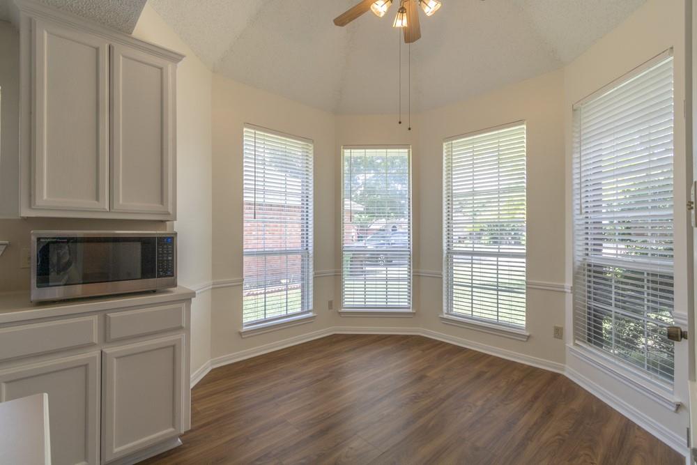 2411 Raintree Path Round Rock, TX 78664 - Photo 9 of 28 a view of an empty room with a window and wooden floor