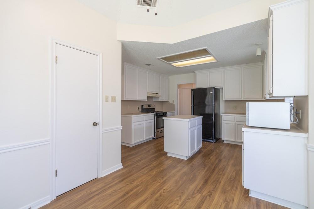 2411 Raintree Path Round Rock, TX 78664 - Photo 10 of 28 a kitchen with stainless steel appliances a refrigerator and a stove top oven