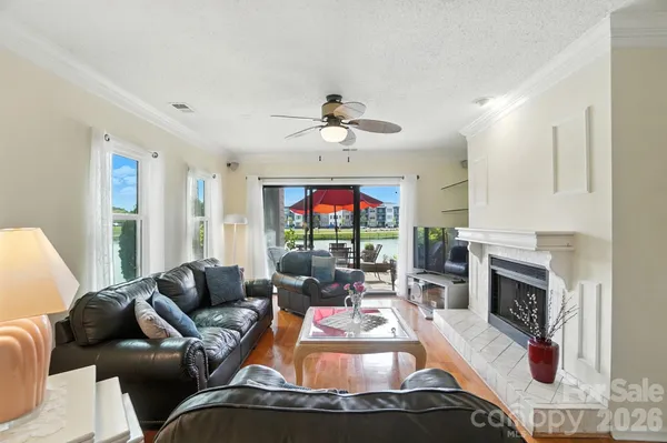 a living room with furniture a fireplace and a flat screen tv