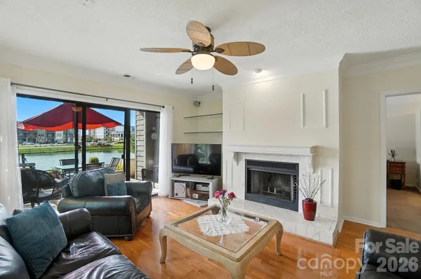 a living room with furniture a fireplace and a flat screen tv