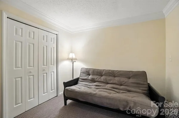 a living room with furniture and a ceiling fan