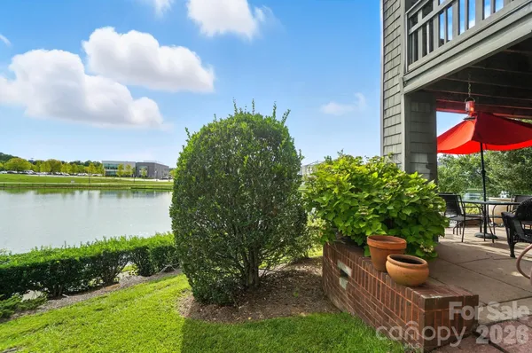 a backyard of a house with lake view and a garden
