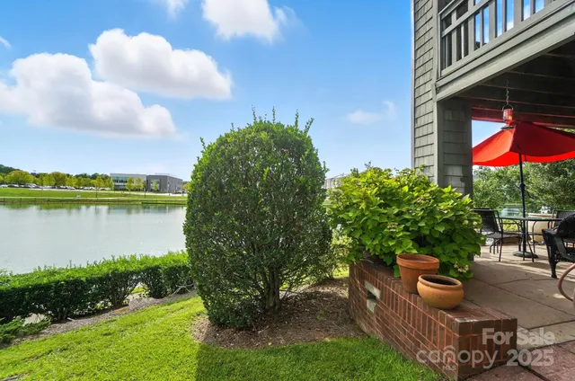 a backyard of a house with wooden floor and lake view