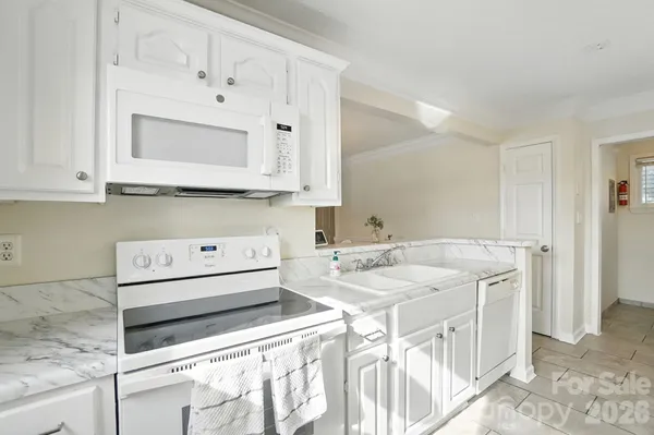 a kitchen with stainless steel appliances granite countertop a sink and a stove