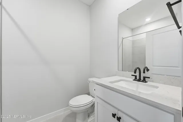 a bathroom with a sink toilet and mirror