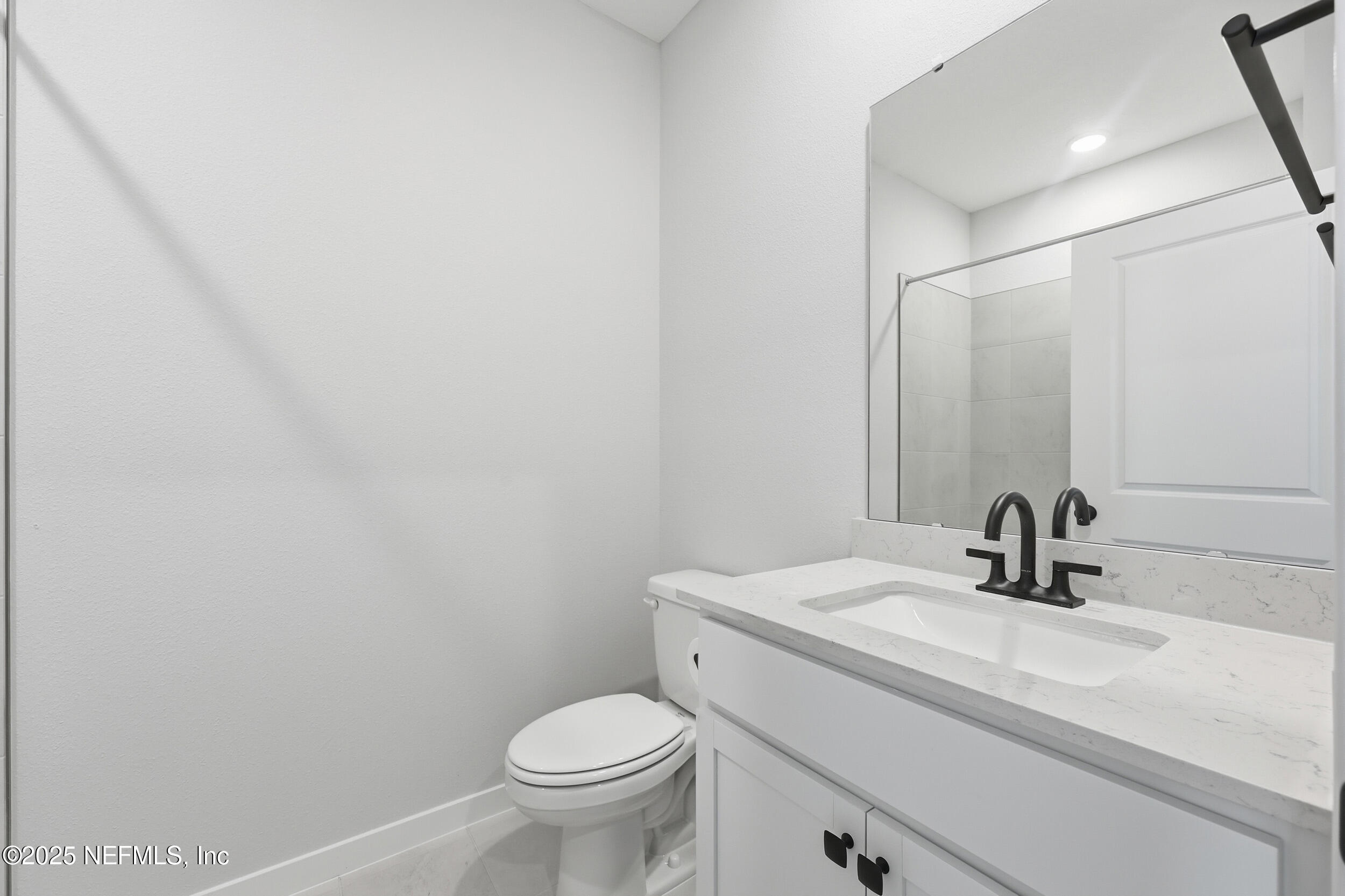96509 Stillpoint Way Fernandina Beach, FL 32034 - Photo 16 of 32 a bathroom with a sink toilet and mirror