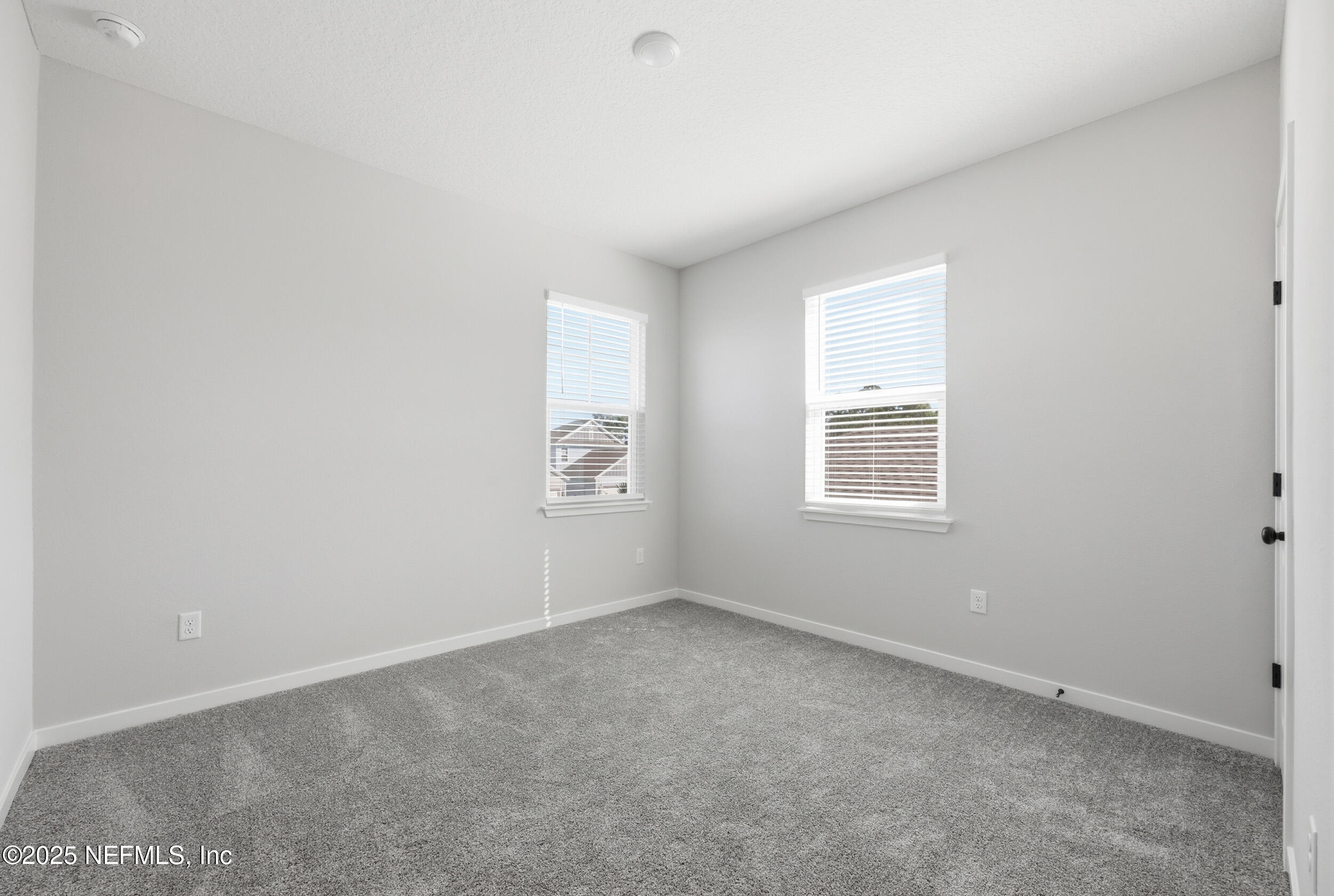 96509 Stillpoint Way Fernandina Beach, FL 32034 - Photo 24 of 32 an empty room with windows