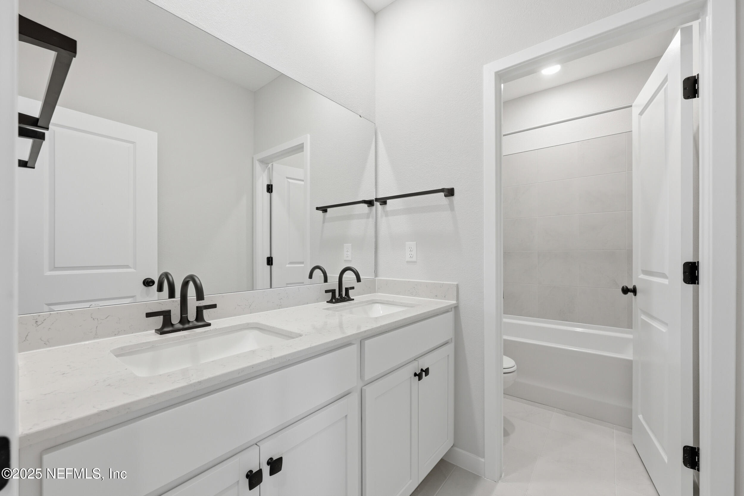 96509 Stillpoint Way Fernandina Beach, FL 32034 - Photo 25 of 32 a bathroom with a sink tub vanity and a mirror
