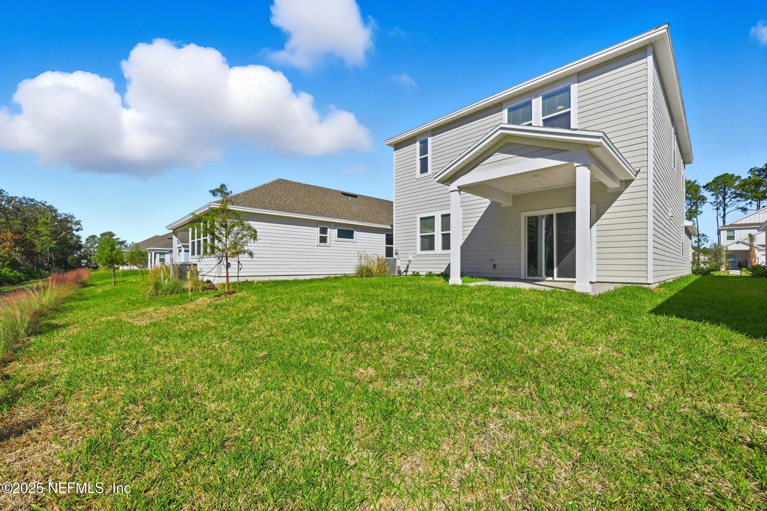 96509 Stillpoint Way Fernandina Beach, FL 32034 - Photo 28 of 32 a front view of a house with garden