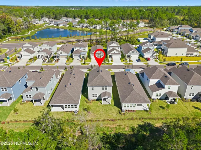 an aerial view of residential houses with outdoor space