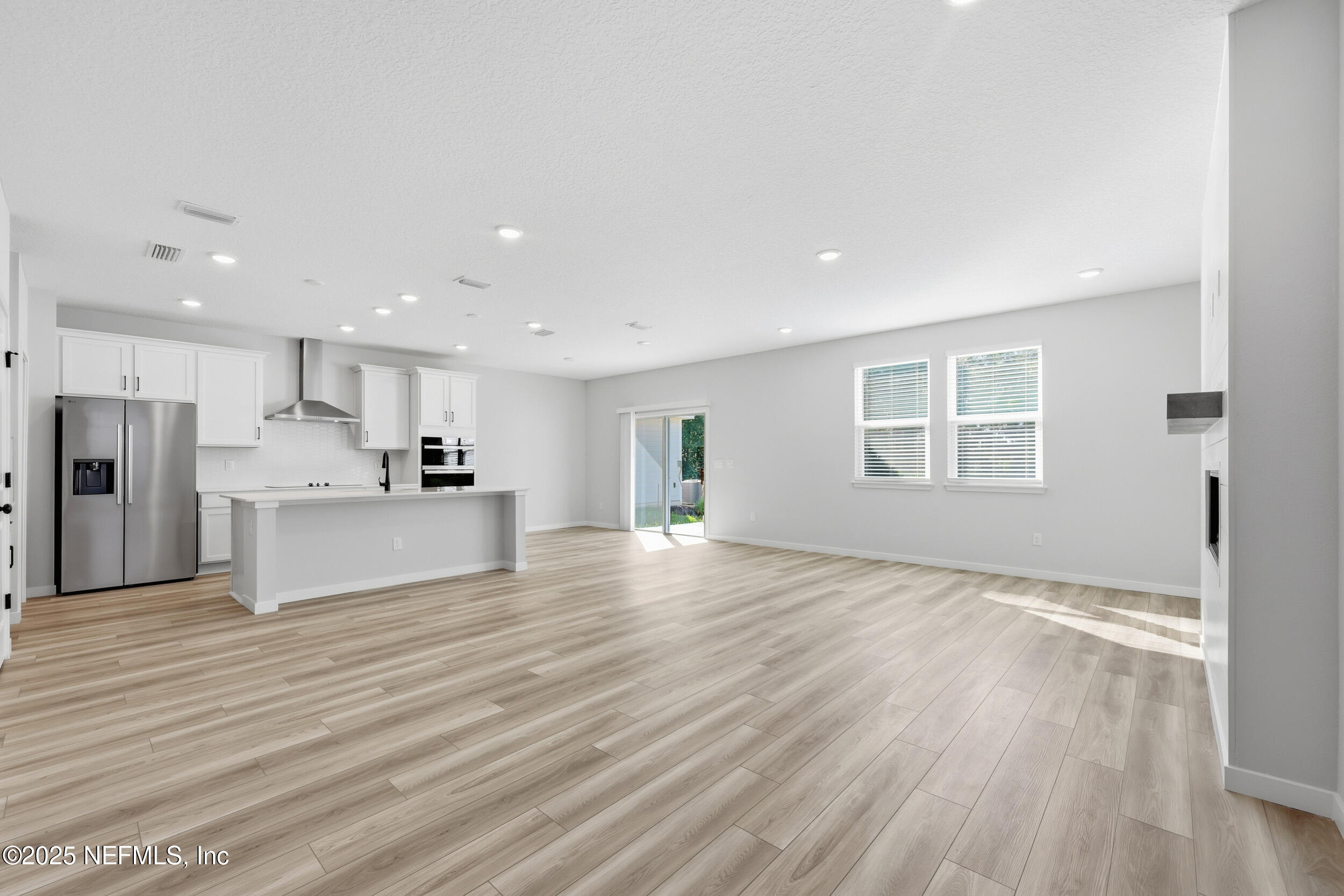 96509 Stillpoint Way Fernandina Beach, FL 32034 - Photo 5 of 32 a view of kitchen with refrigerator microwave and wooden floor