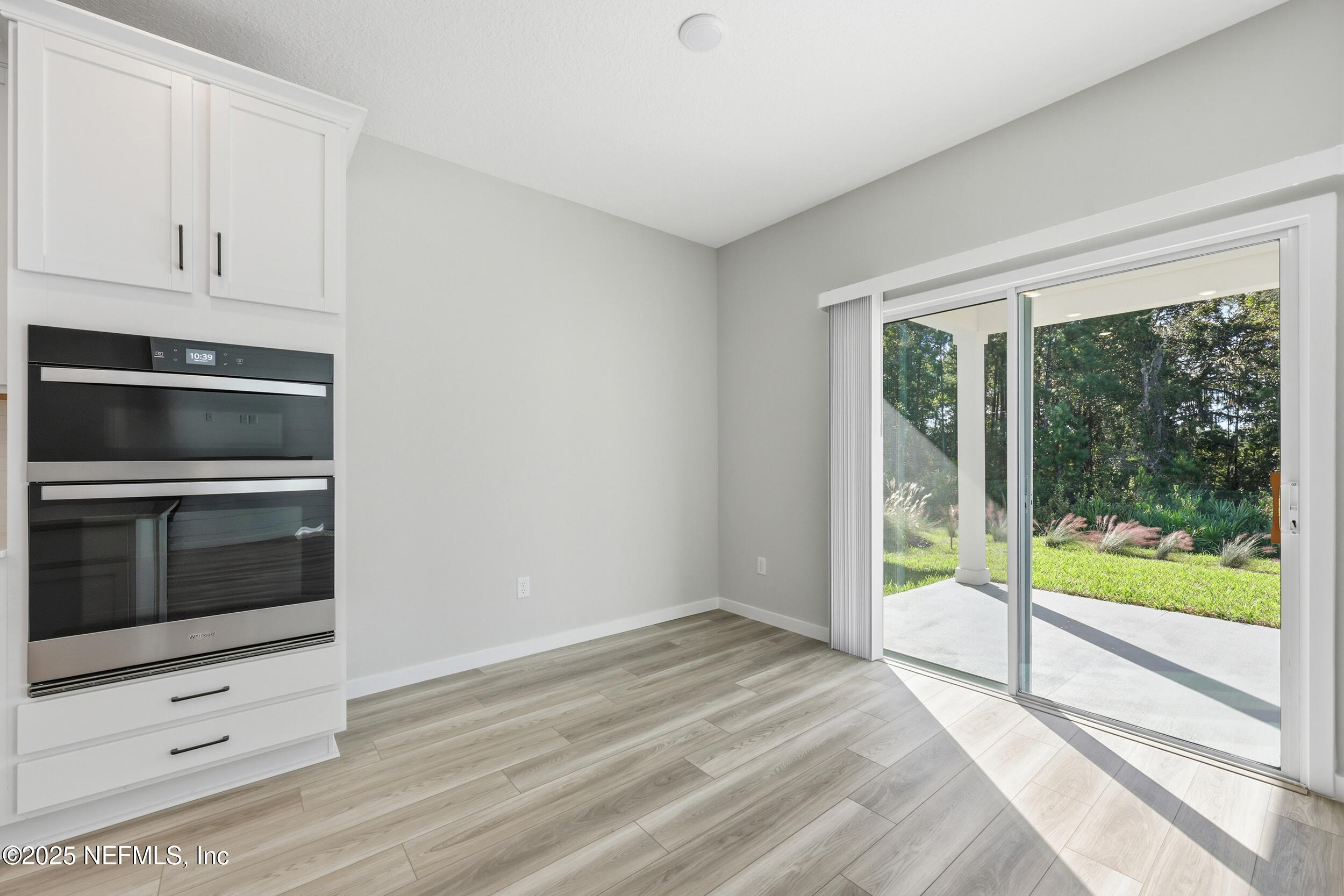 96509 Stillpoint Way Fernandina Beach, FL 32034 - Photo 10 of 32 a view of empty room with wooden floor and fan