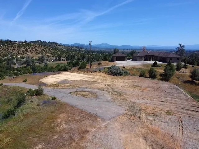 a view of a dry yard with mountains