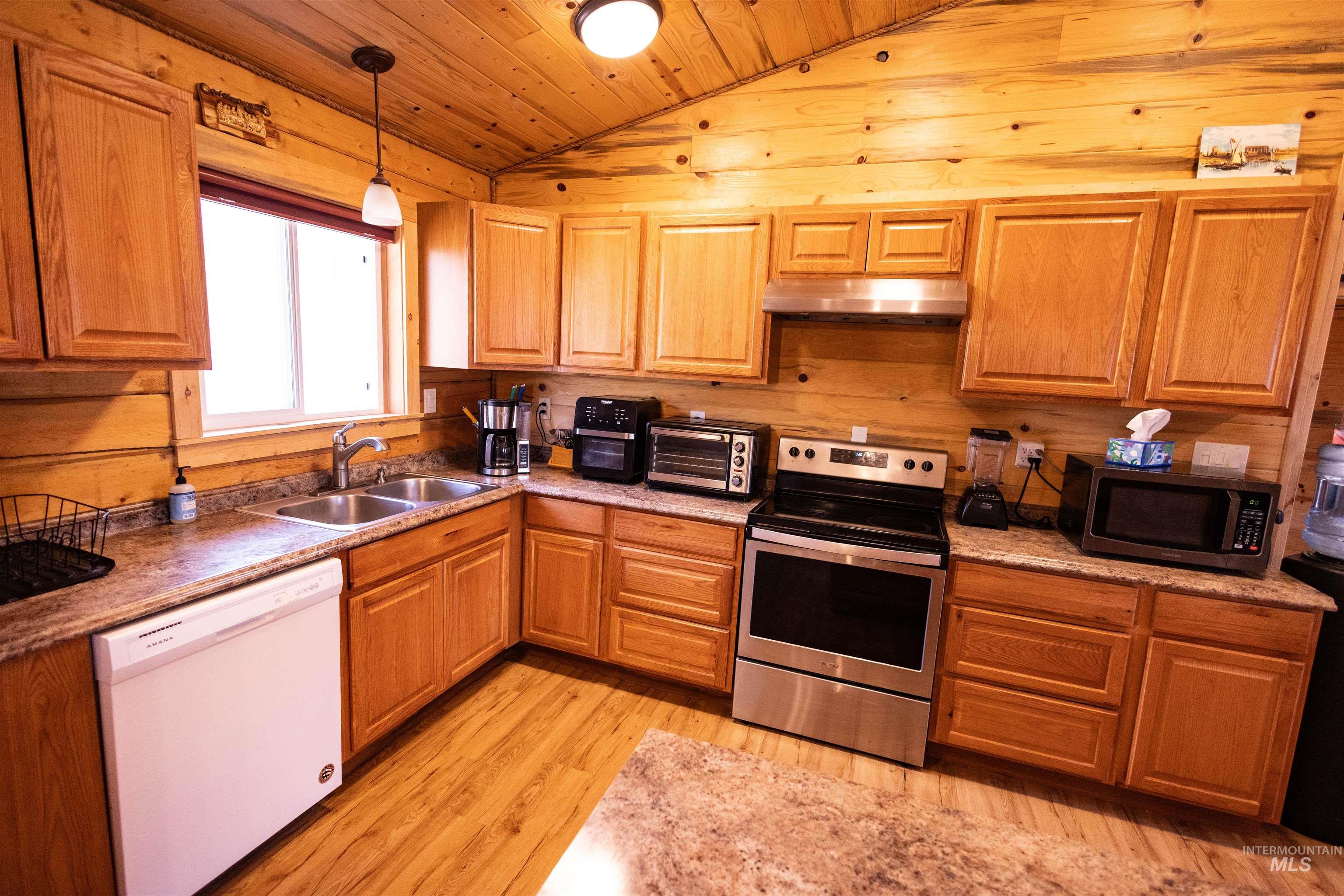 830 Leitch Creek Road Kooskia, ID 83539 - Photo 12 of 49 Kitchen with appliances with stainless steel finishes, wooden ceiling, lofted ceiling, hanging light fixtures, and light wood finished floors