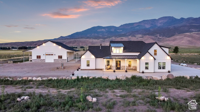 1952 Highway 118 Monroe, UT 84754 - Photo 67 of 88 Modern farmhouse featuring a standing seam roof, a metal roof, a mountain view, a porch, and a garage