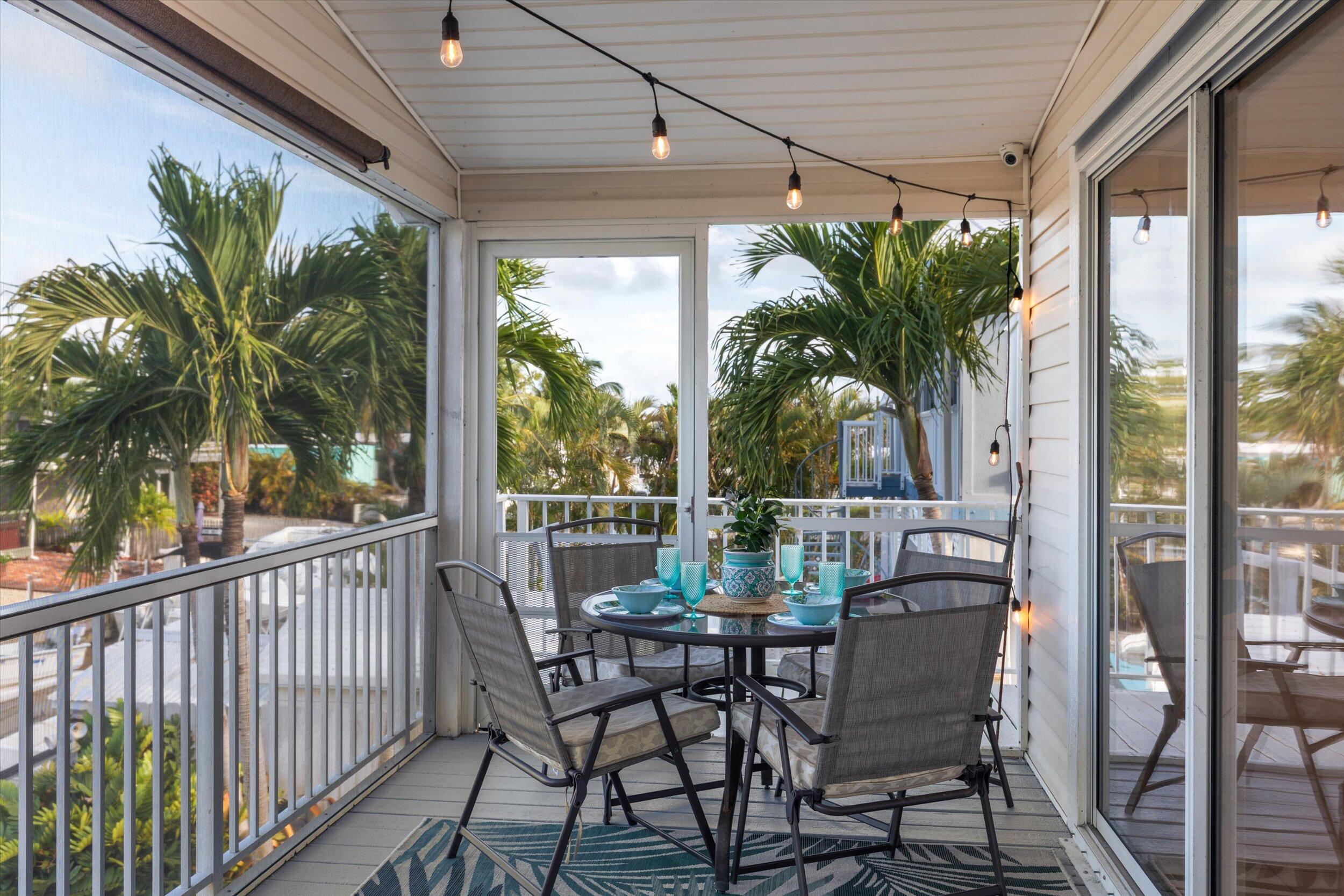 157 Mars Lane Key West, FL 33040 - Photo 7 of 41 a view of a patio with table and chairs and potted plants