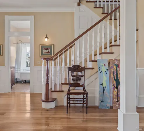 a view of entryway and hall with wooden floor