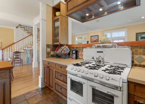 a kitchen with a sink stove and cabinets