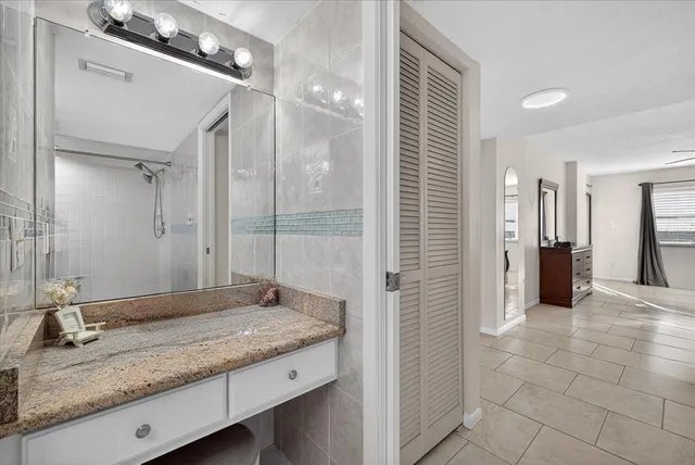 an aerial view of residential houses with outdoor space and ocean view