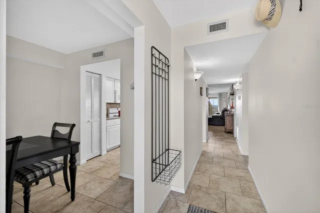 a view of a dining room with a table and chairs